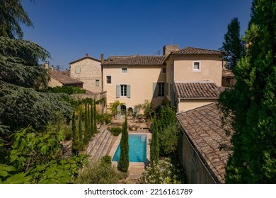 Ales, France - June 16th 2022 : Drone View Of A Beautiful Villa In The South Of France With Its Small Courtyard, Small Pool, Cypresses And Large Trees On The Sides