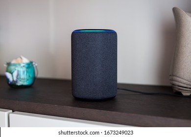 Alexa Portable Echo Speaker Device On A Wooden Shelf. Italy, Torino - February 2020