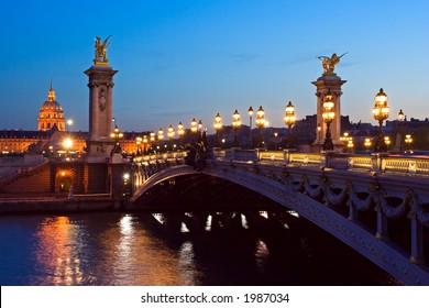 The Alexander III bridge and the dome of the Invalides at night - Paris, France