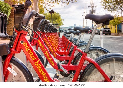 Alexandria, VA - October 24, 2016: Row of Red Bikes at a Capital Bikeshare Station in Old Town. Capital Bikeshare is metro DC's bikeshare service, with 3,700 bikes and 440 stations.