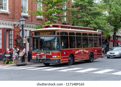 Alexandria, Virginia--August 20, 2018.  A trolley bus drives down the street in Alexandria in the summer.
