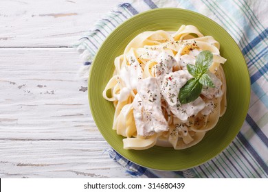 Alfredo Pasta In Cream Sauce With Chicken On A Plate. Horizontal View From Above
