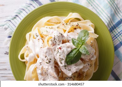 Alfredo Pasta In Cream Sauce With Chicken Closeup On A Plate. Horizontal View From Above
