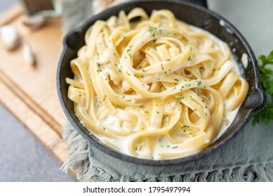 Alfredo Pasta Dinner With Creamy White Sauce And Herbs