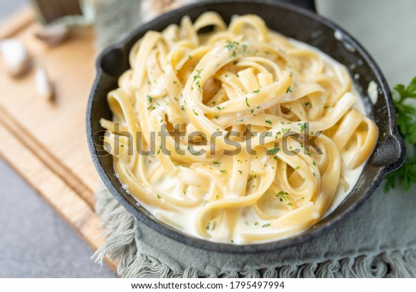 Alfredo\
pasta dinner with creamy white sauce and\
herbs