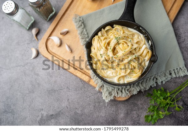 Alfredo\
pasta dinner with creamy white sauce and\
herbs