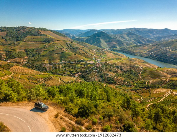 Algarve, Portugal - August 2020: Lifestyle\
photo of a black Land Rover Discovery 4 driving along scenic\
Portuguese coastline.