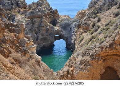 Algarve, Portugal, rock arch in water, Ponta da Piedade rock formations. Travel destination in Europe.