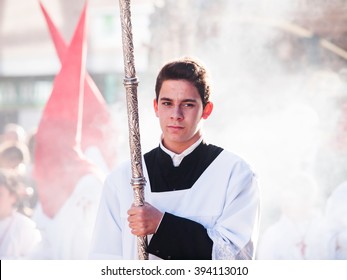 Algeciras, Spain - 20 March, 2016 Altar server in front of a cloud of incence during the Palm Sunday procession.