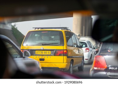 Algiers - Algeria, February 20, 2021: A Yellow Taxi Van In The Traffic  