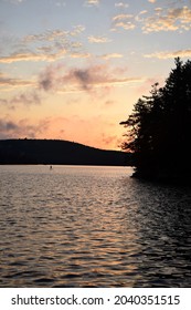 Algonquin Provincial Park, Ontario, Canada: Portrait View Of Stand Up Paddle Board (SUP) Paddler On The Lake During Sunset