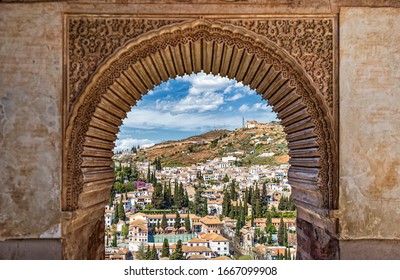 Alhambra, Granada, Spain - 30 March 2019: View over Albaicin hill in Granada from a decorated window in the Alhambra palace, Granada, Spain