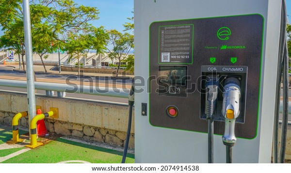 Alicante, AlicanteEspaña; 11 15 2021 : Iberdola\
electric car recharging station in outdoor parking lot of shopping\
center