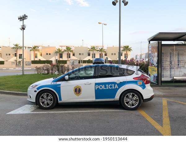 Alicante, Spain -\
April 2021: local police car parked near Zenia Boluevard shopping\
center, bus stop urban area\
