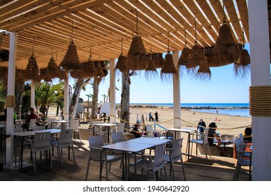 Alicante, Spain- March 18, 2021: Beach Bar Restaurant With Empty Terrace On Almadraba Beach In A Sunny Day