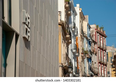 Alicante, Spain - October 6 2018: Facades Of Colorful Houses In Street Of Alicante Next To The MACA