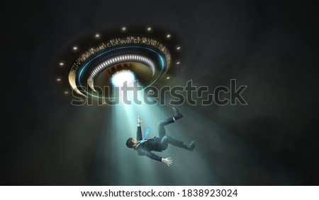 Alien abduction concept. Young man is abducted by UFO.