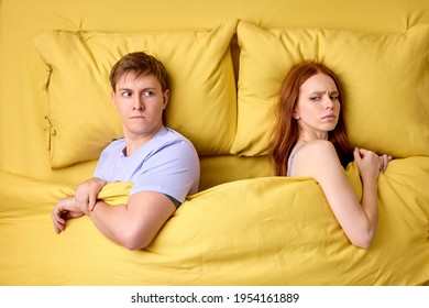 Alienated Millennial Young Couple In Bed, Does't Pay Attention To Each Other Not Talking. Top Down Shot.