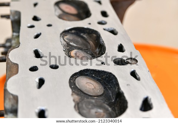 Aligned and ground cylinder head with an\
abrasive stone on a surface\
grinder.