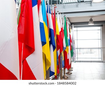 Aligned Multicolored World Flags Indoors In Conference Hall No People