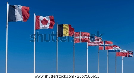 Alignment of national flags of the Allies of the Second World War along the beach