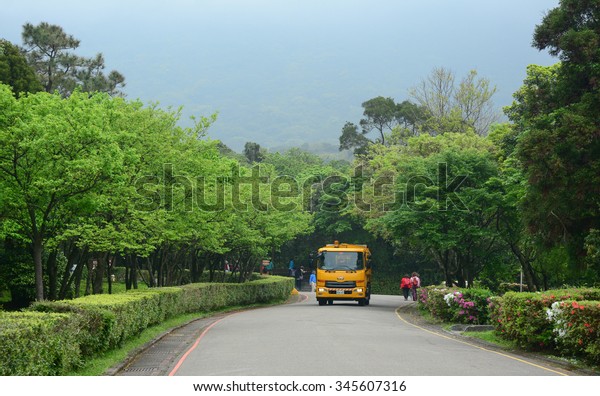 Alishan, Taiwan - April\
12, 2015. Tourist bus running along the road in Alishan, Taiwan.\
This bus leaves from Sun Moon Lake heading to Alishan National\
Park, Taiwan.