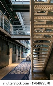 Alkmaar, The Netherlands-June 2021; View From Under Steel Stairs Into Hallway With Prison Cells Of Former Prison Now Renovated Boutique The Fallon Hotel Retaining The Original Interior Features