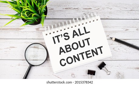 IT'S ALL ABOUT CONTENT text concept write on notebook with office tools on wooden background