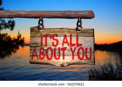 It's All About You Motivational Phrase Sign On Old Wood With Blurred Background