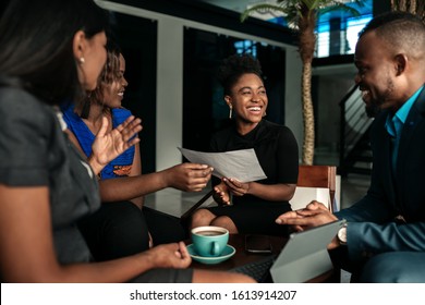 All African casual business meeting. Candid real happy moment between four work colleagues.