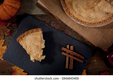 All American Apple Pie Slice With Full Pie Close In A Top Down Overhead Rustic Fall Themed Setting