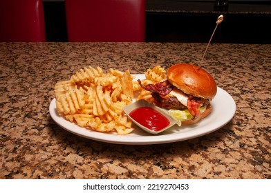 All American Classic Bacon Cheeseburger On A Sesame Seed Bun.