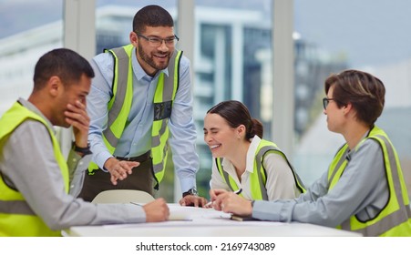 Its All Fun And Games In The Boardroom. Cropped Shot Of A Group Of Young Construction Workers Laughing During A Meeting In The Boardroom.