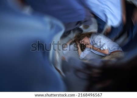 Its all too much. Shot of a young woman curled up on the floor in a panic state.
