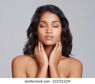 All Natural Beauty. Shot Of A Beautiful Young Posing Over A Gray Background.