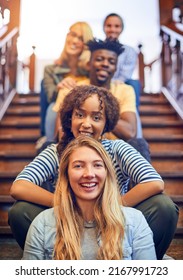 All On The Journey Of A Better Future. Portrait Of A Group Of Diverse University Students Sitting In A Row On The Staircase On Campus.