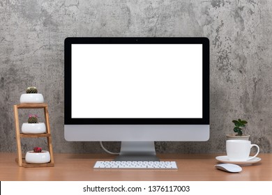 All in one computer, mouse, keyboard, cactus pots, plant vase and coffee cup on wooden table - Shutterstock ID 1376117003