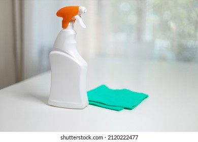 All Purpose Cleaner Disinfectant Spray Bottle With Towel On White Wooden Table At Home Or Office Concept Of Disinfection And Prevention Of Covid-19.