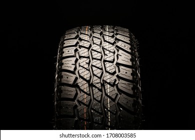 all terrain new tire for off-road and off-road vehicles and crossovers close-up on a black background