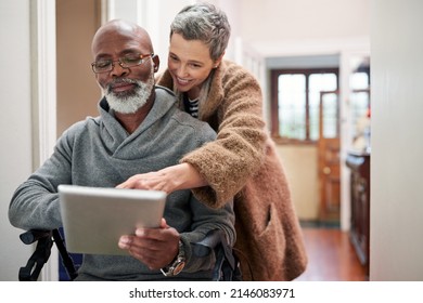 All that matters is that were together. Cropped shot of an affectionate senior couple using a tablet at home with the man sitting in a wheelchair. - Powered by Shutterstock