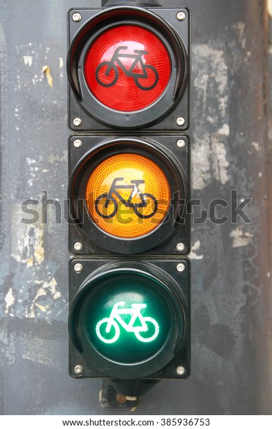 All three lights\
as a traffic sign in the city. Red orange green colored traffic\
lights as a background\
