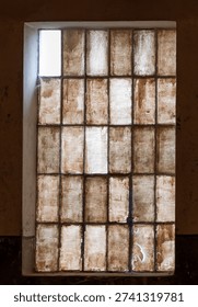 All windows are closed and dark except one with sunlight. A glimmer of hope.