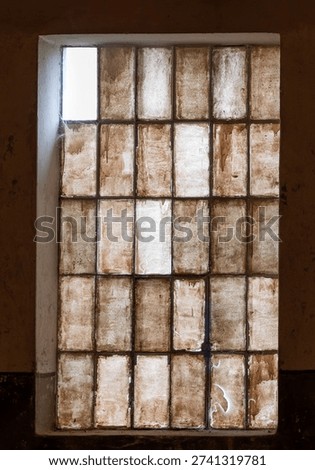 All windows are closed and dark except one with sunlight. A glimmer of hope.