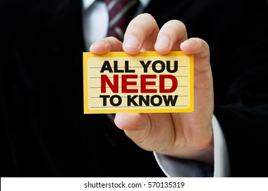 All You Need To Know. Businessman Holding A Card With A Message Text Written On It