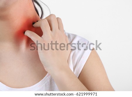 Allergies and sore throat concept. Woman scratching neck, closeup