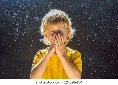 Allergy to dust. Boy sneezes because he is allergic to dust. Dust flies in the air backlit by light - Powered by Shutterstock