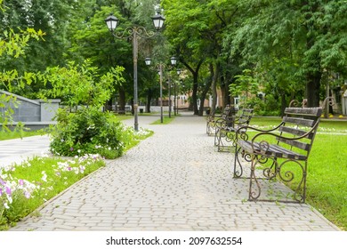 Alley With Lamp Posts And Benches In Beautiful City Park