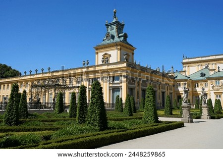 Alley to palace at Wilanow district in European Warsaw capital city of Poland in Masovian, clear blue sky in 2022 warm sunny spring day on May.
