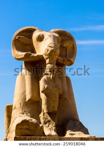 Alley of sphinx in Luxor - landmark of Ancient Egypt. Monumental statue of god Amun with a ram's head - one of symbol of Egyptian mythology and religion, Karnak Temple.