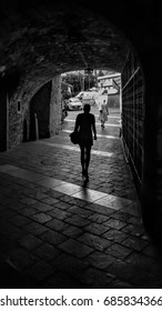 A Alleyway In Italy With Walking Woman